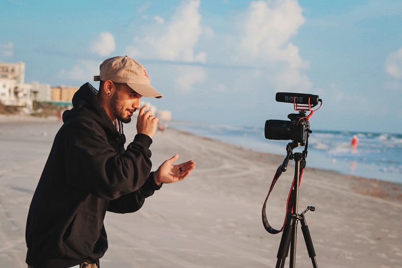 5 must have videos man recording video on beach unsplash column