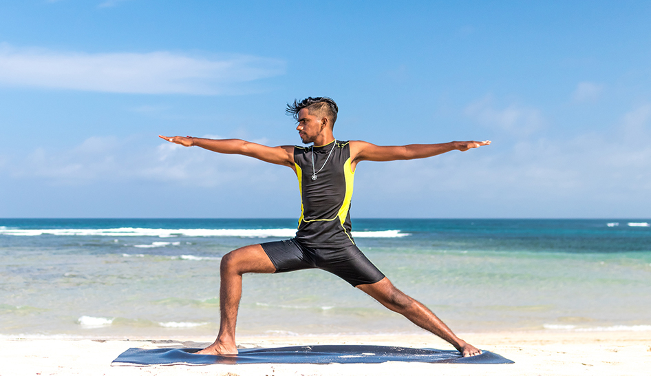 Industry News Man Doing Yoga On Beach Column