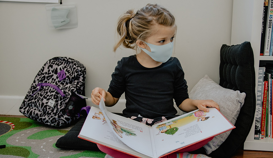 Wellness Girl in Mask Reading Column