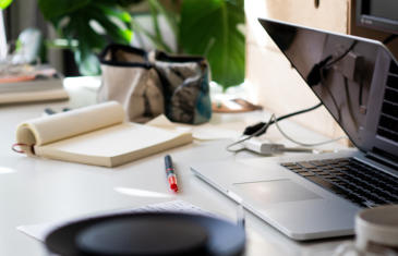 Sales and Marketing desk with notepad laptop red pen stock column