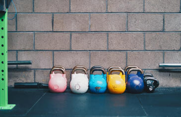 Strategy and finance row of kettlebells Unsplash stock column