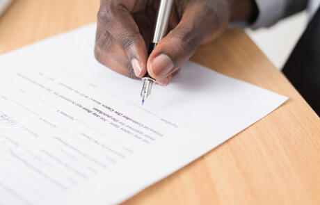 Legal man signing document unsplash stock column