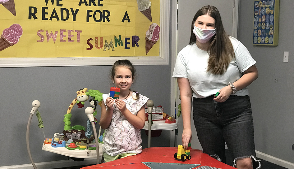 Coronavirus YCRC worker with mask and child column