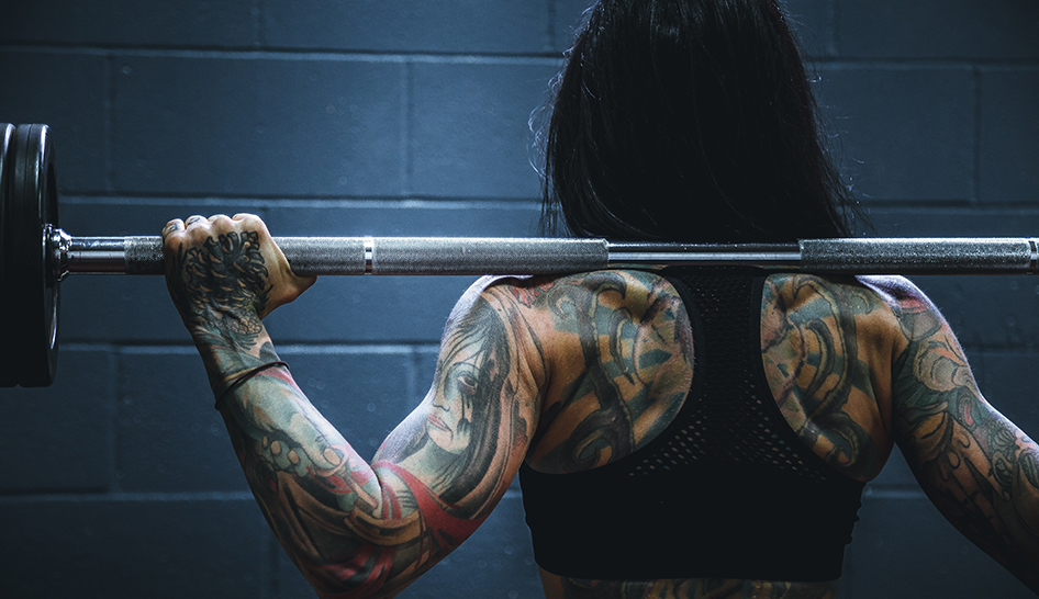 Industry news woman barbell Unsplash stock column