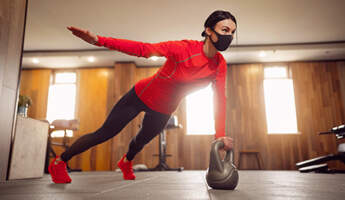 FP sport girl mask from coronavirus doing kettlebells planking listing